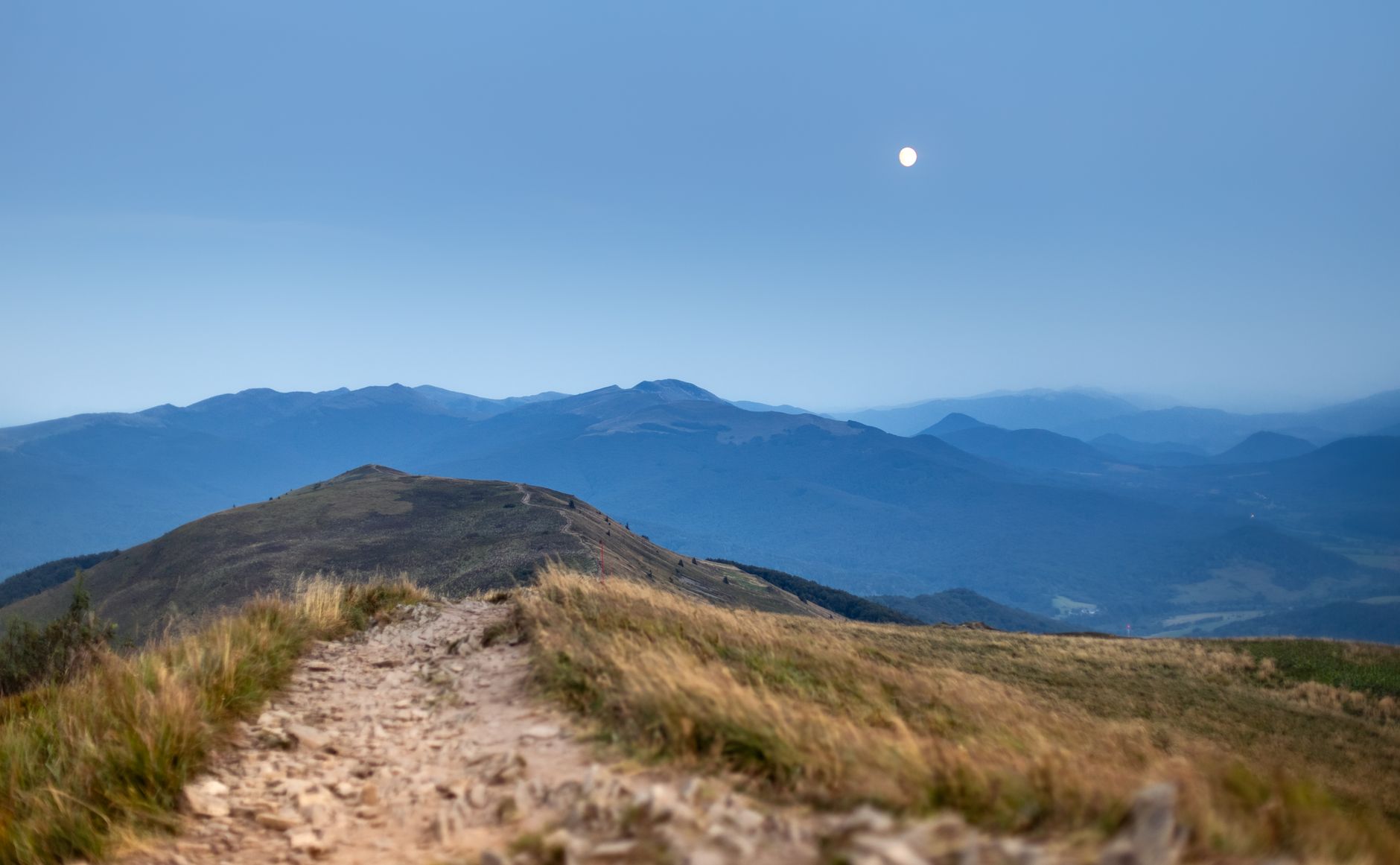 A mesmerizing view of Bieszczady mountains under the moonlight in Podkarpackie, Poland.