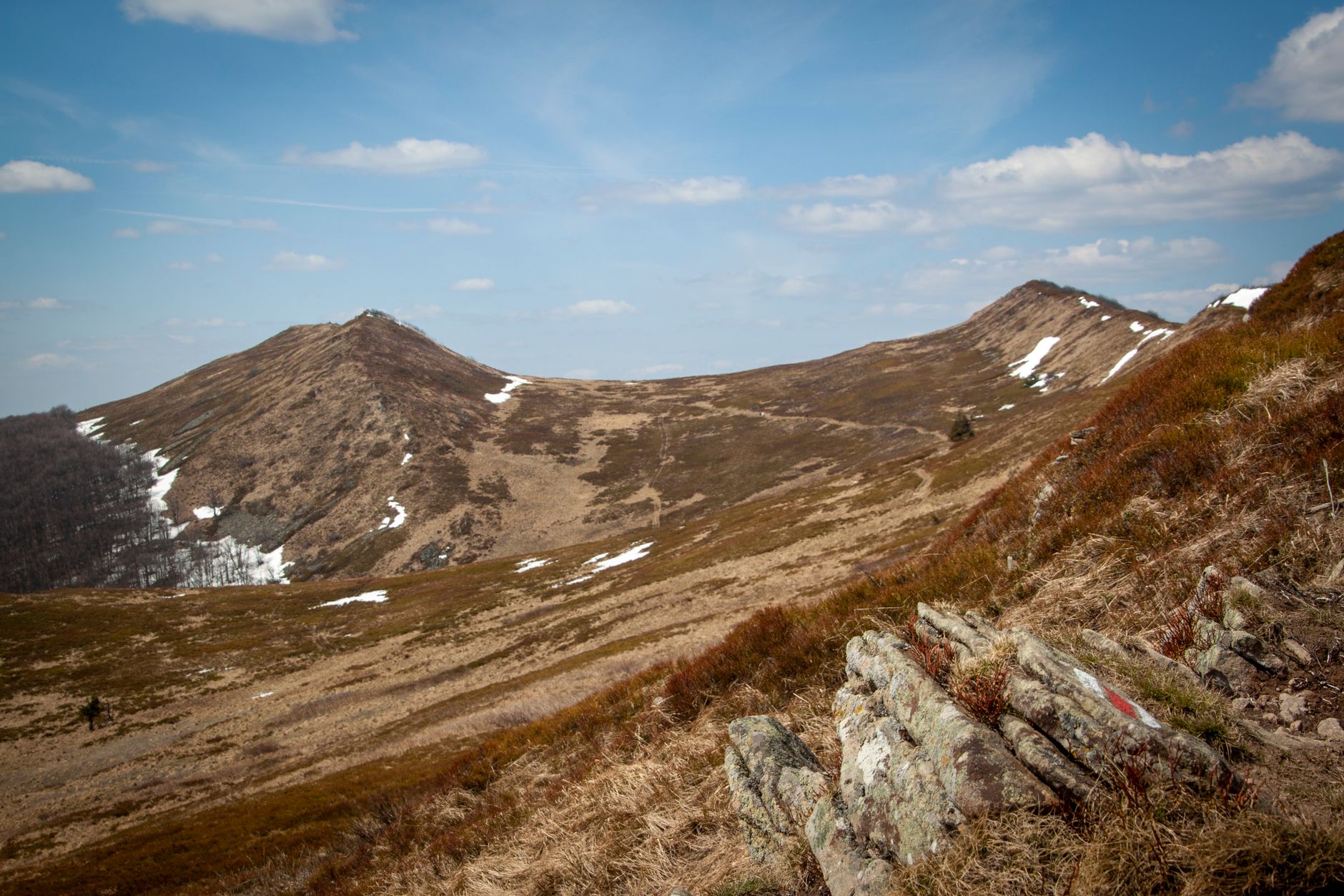 A breathtaking landscape of the Bieszczady Mountains under a clear blue sky.