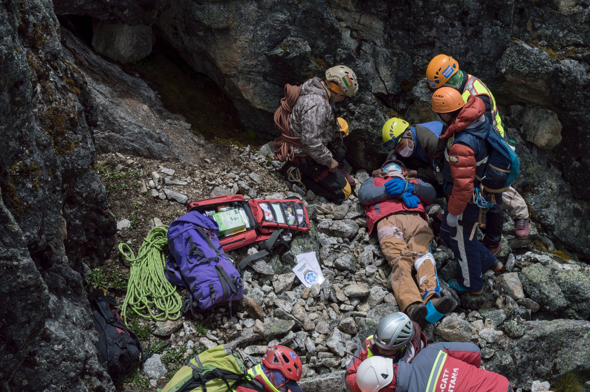 Emergency team provides aid to an injured climber during a mountainside rescue mission.