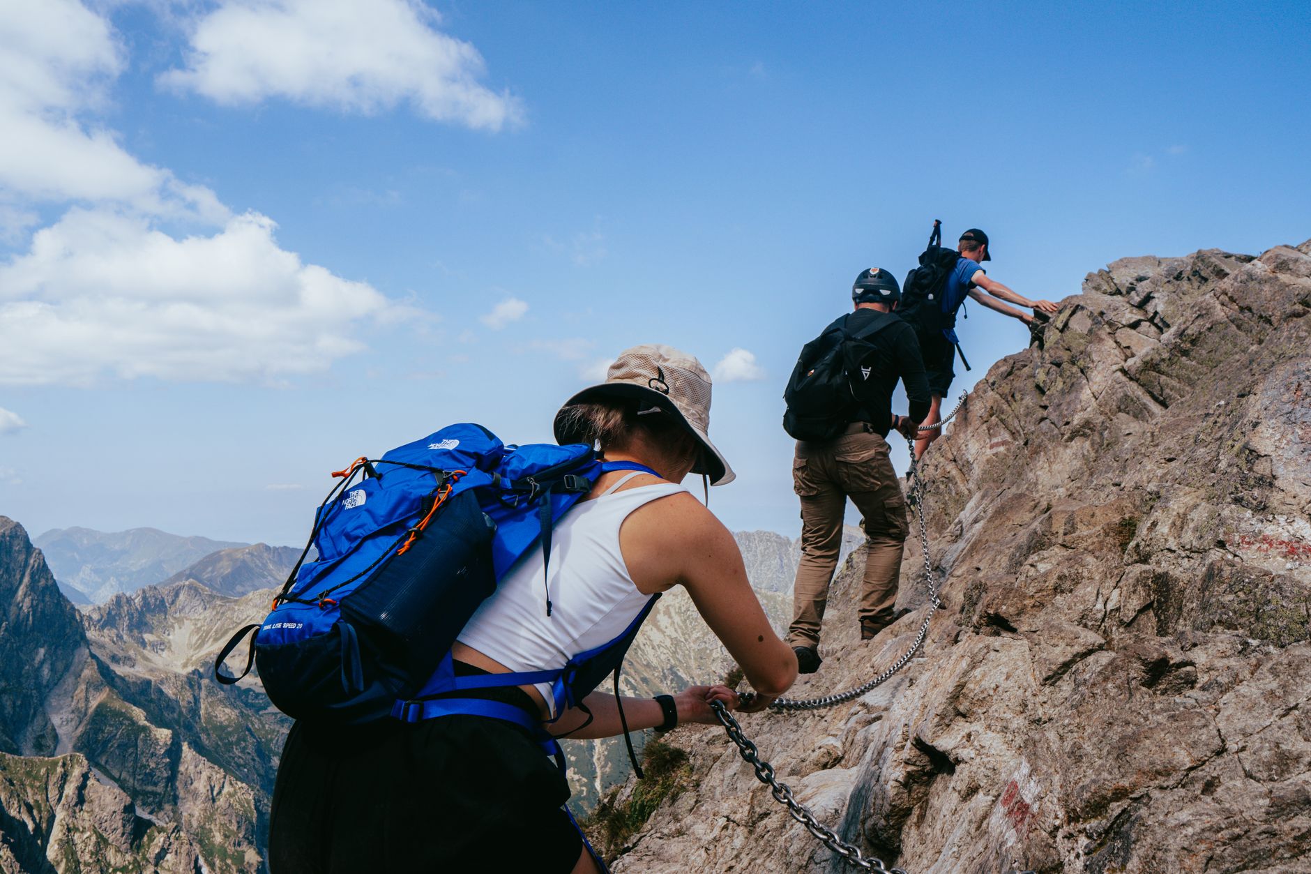 Adventurers climb a rocky path in the stunning High Tatras, Zakopane, Poland.
