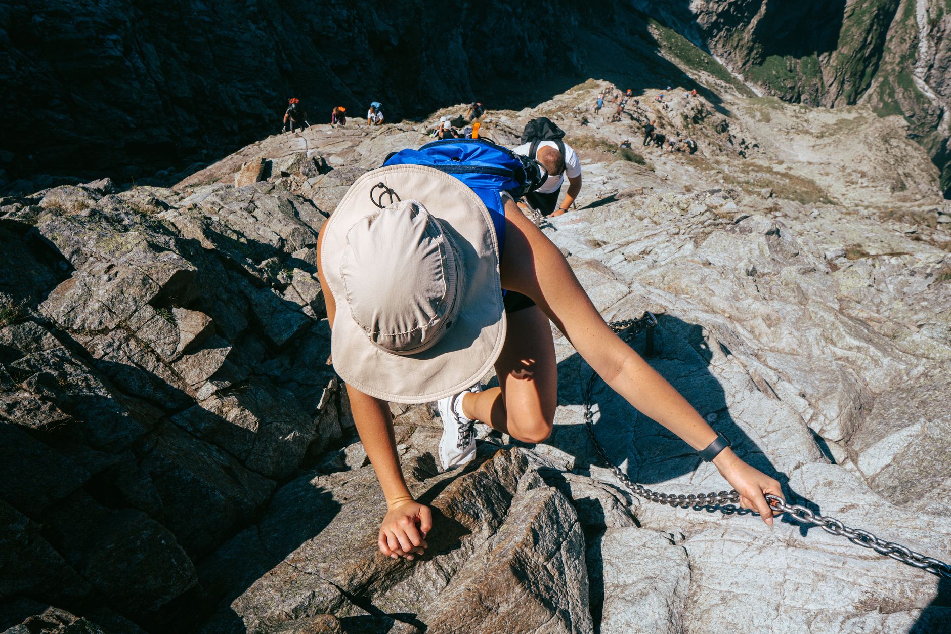 A climber tackles a rocky ascent in the Tatra Mountains during summer.