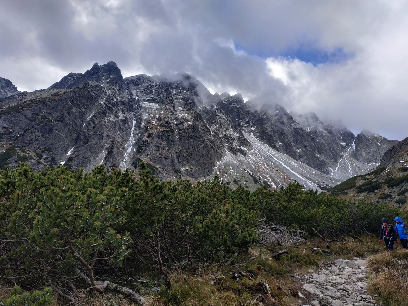 Breathtaking mountain scenery with rocky peaks and clouds, perfect for hiking and adventure enthusiasts.