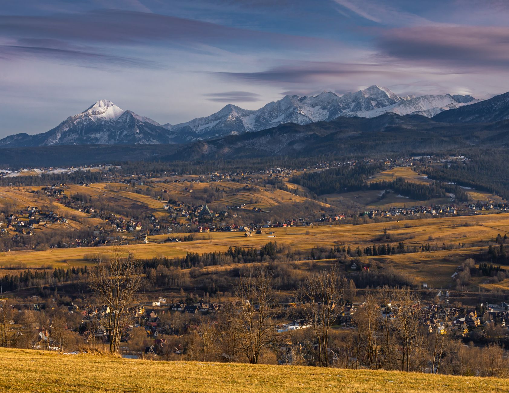 Scenic view of Zakopane with the Tatra Mountains in the background during fall.