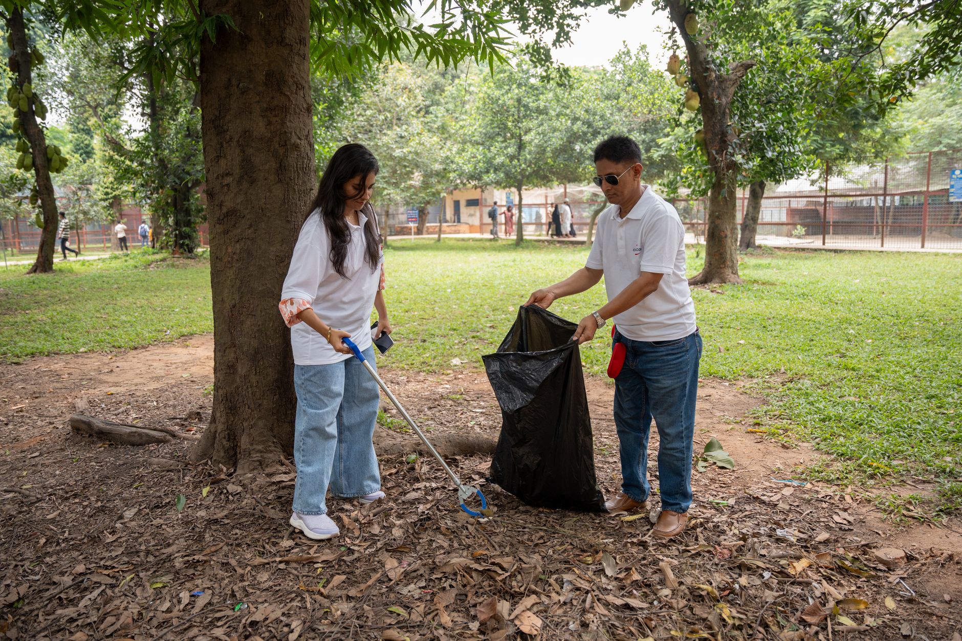 A group of volunteers cleaning up a park, promoting environmental awareness and community service.