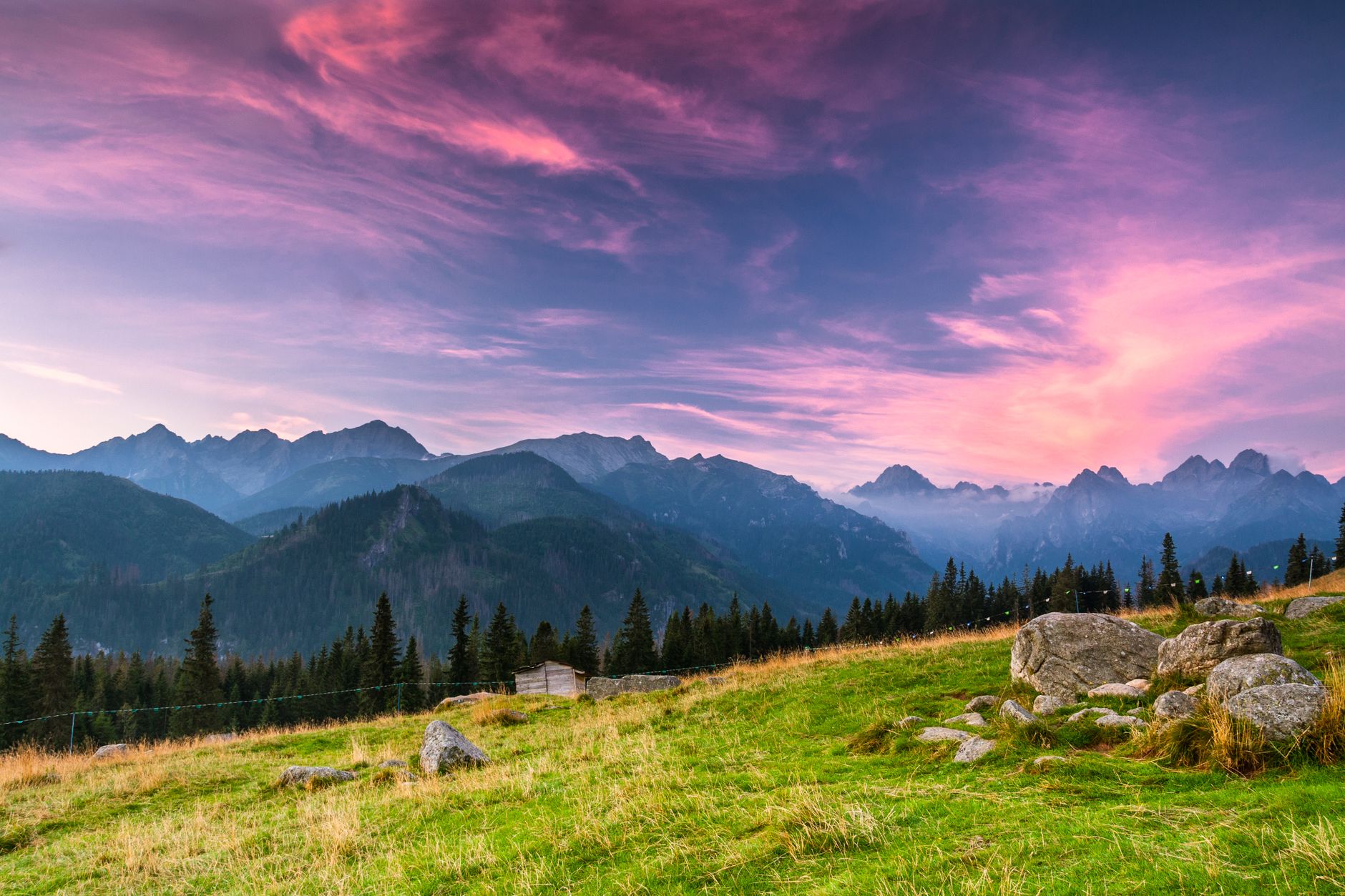 Breathtaking view of the Tatra Mountains during a pink sunrise in Poland, capturing natural beauty.
