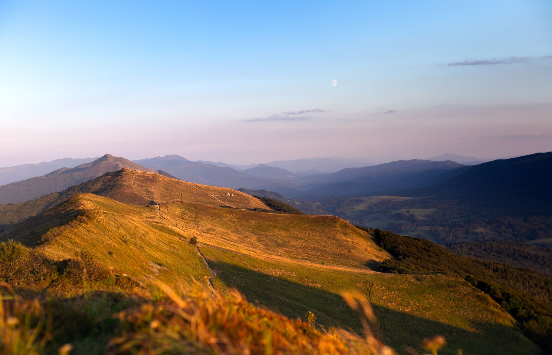 Experience the tranquil beauty of the Bieszczady Mountains captured during a summer sunset in Poland's Podkarpackie Voivodeship.
