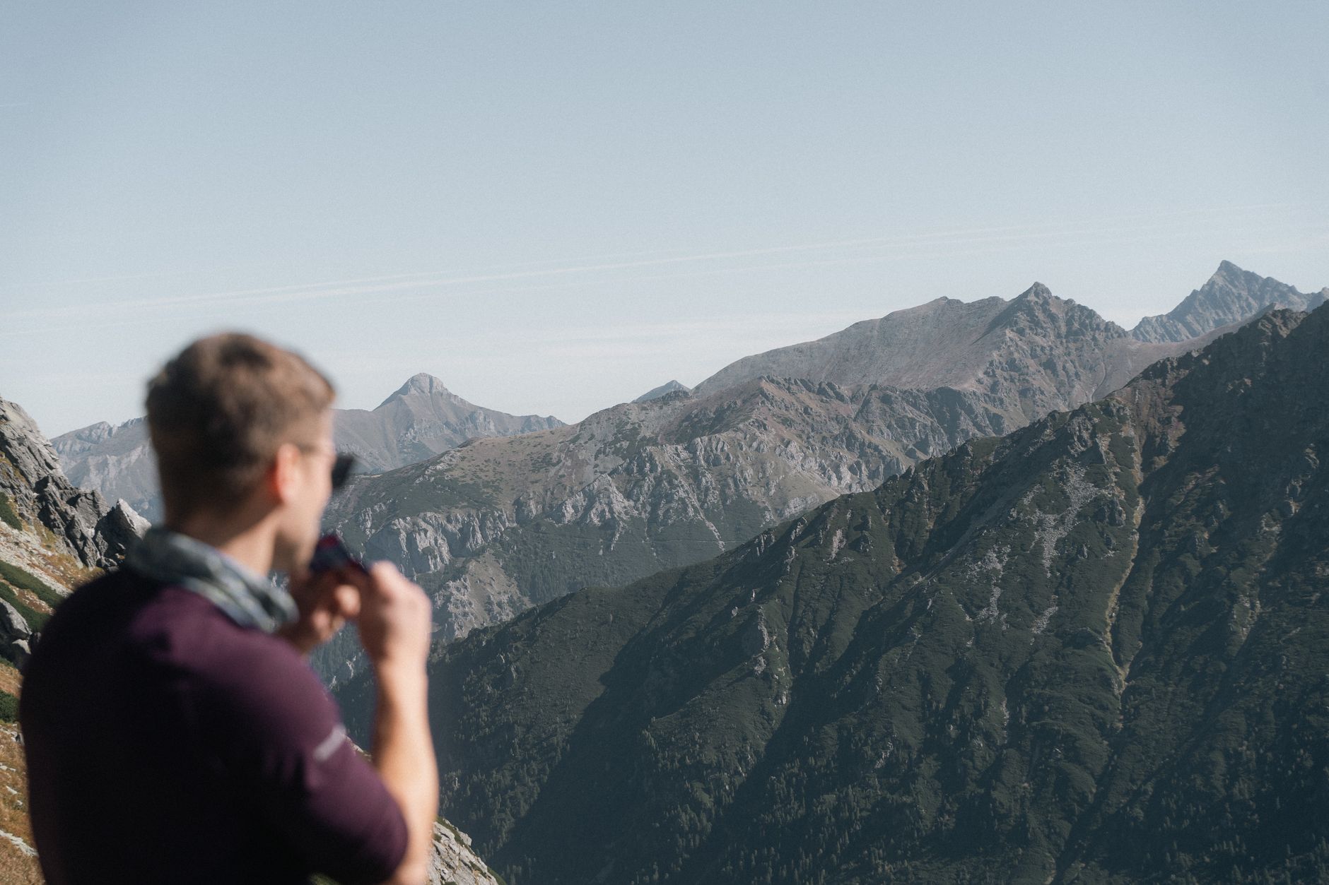 A person enjoying the panoramic view of the Tatra Mountains in Zakopane, Poland.