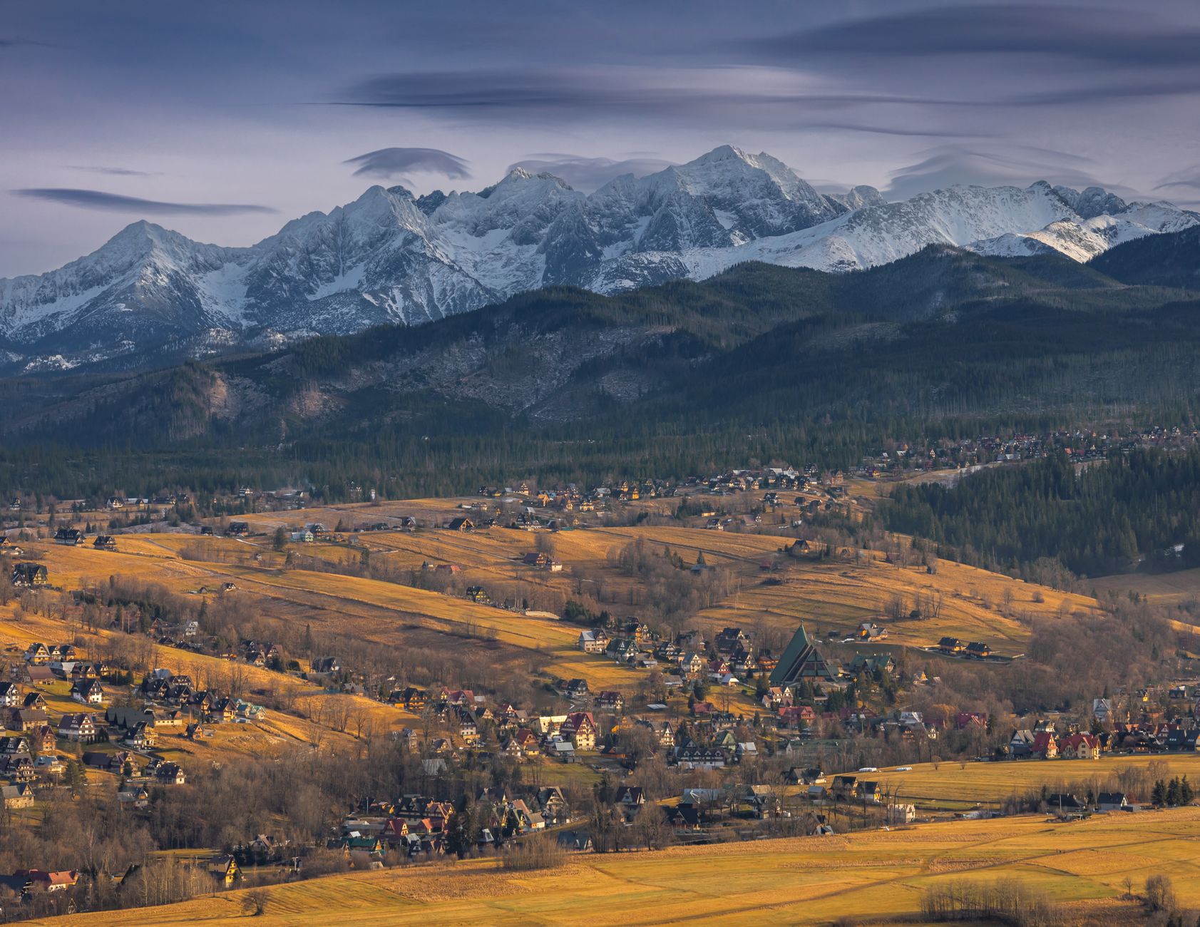 Picturesque landscape of Zakopane with the Tatra Mountains in the background during autumn.