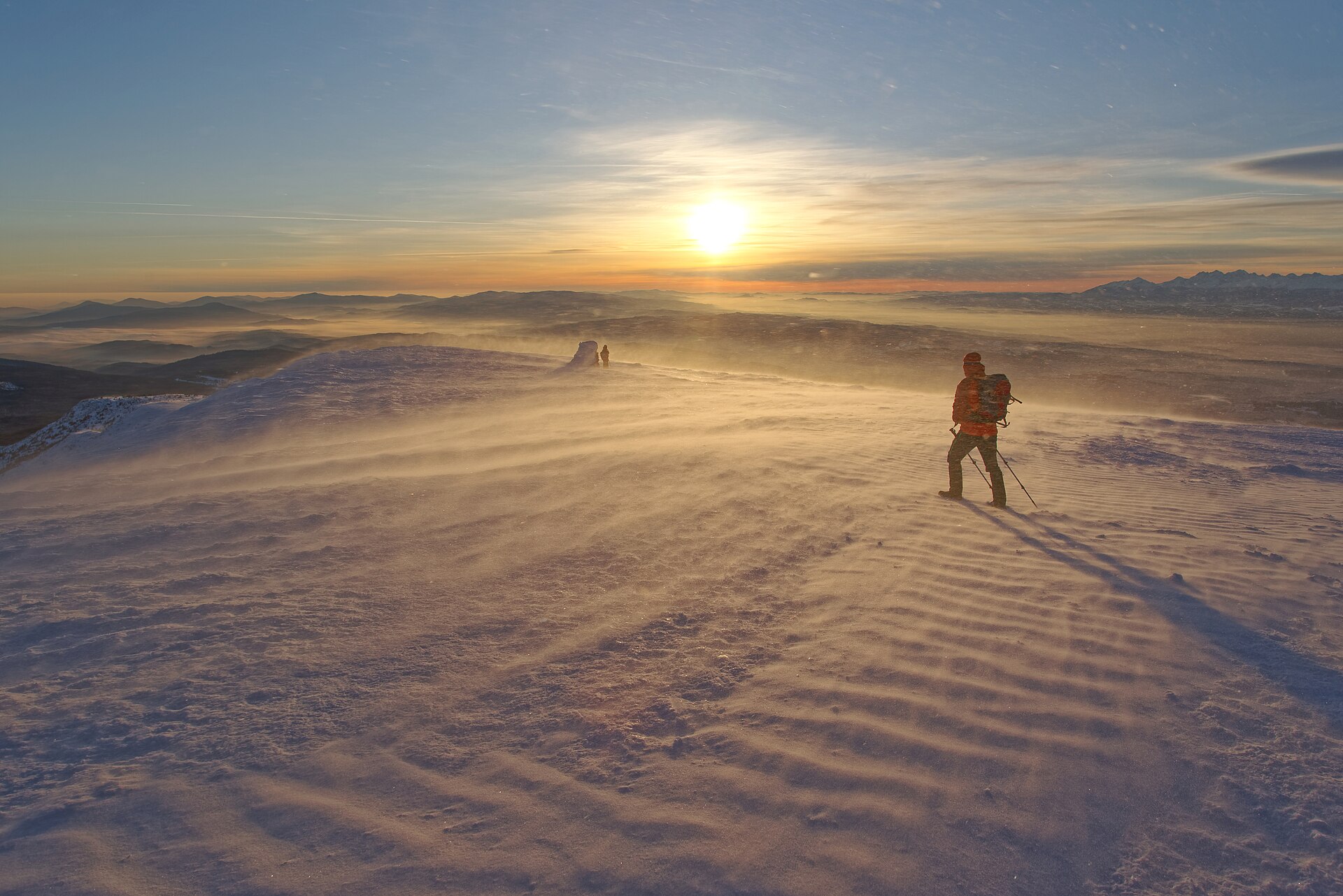 Hiking trail from the Babia Góra peak, after sunrise, in a ground blizzard